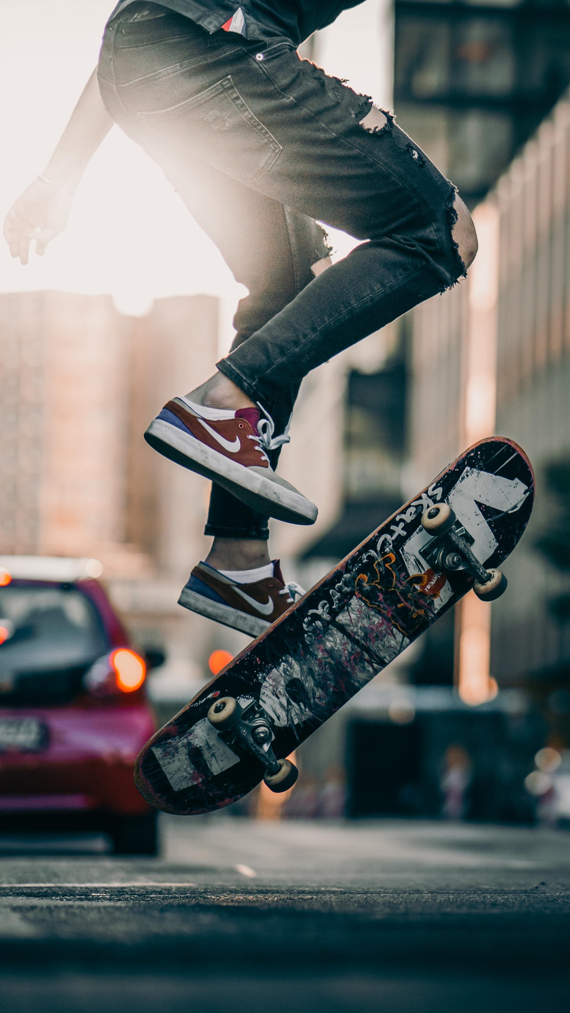 A person is jumping in the air while riding a skateboard.