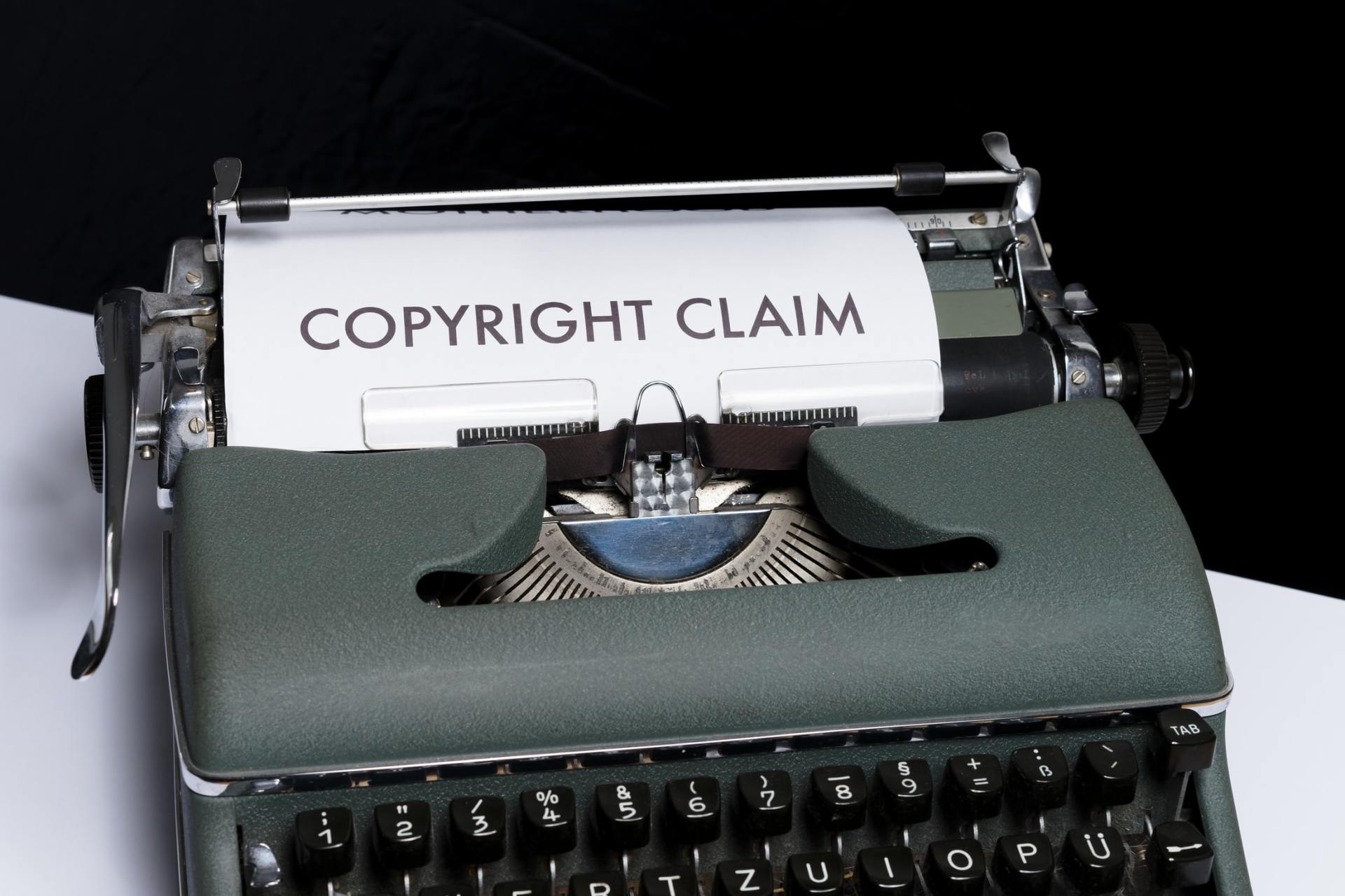 A typewriter with a sheet of paper that says 