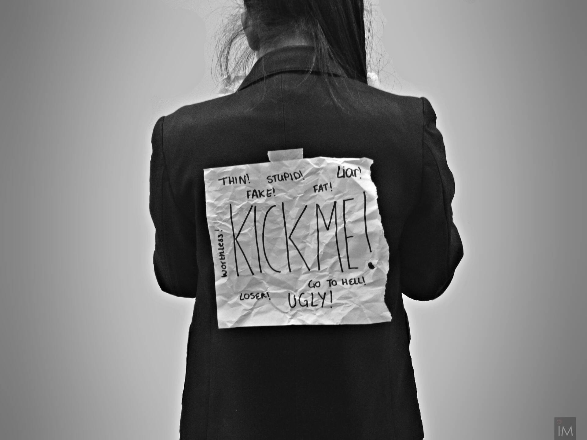 Back view of a person wearing a dark jacket with a