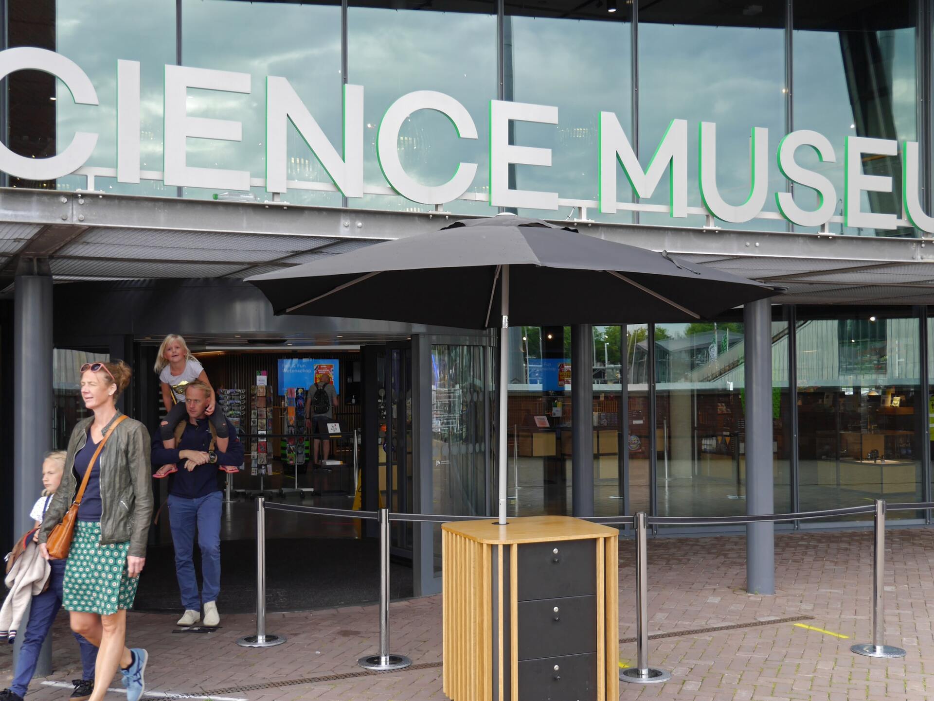 People are walking in front of the science museum