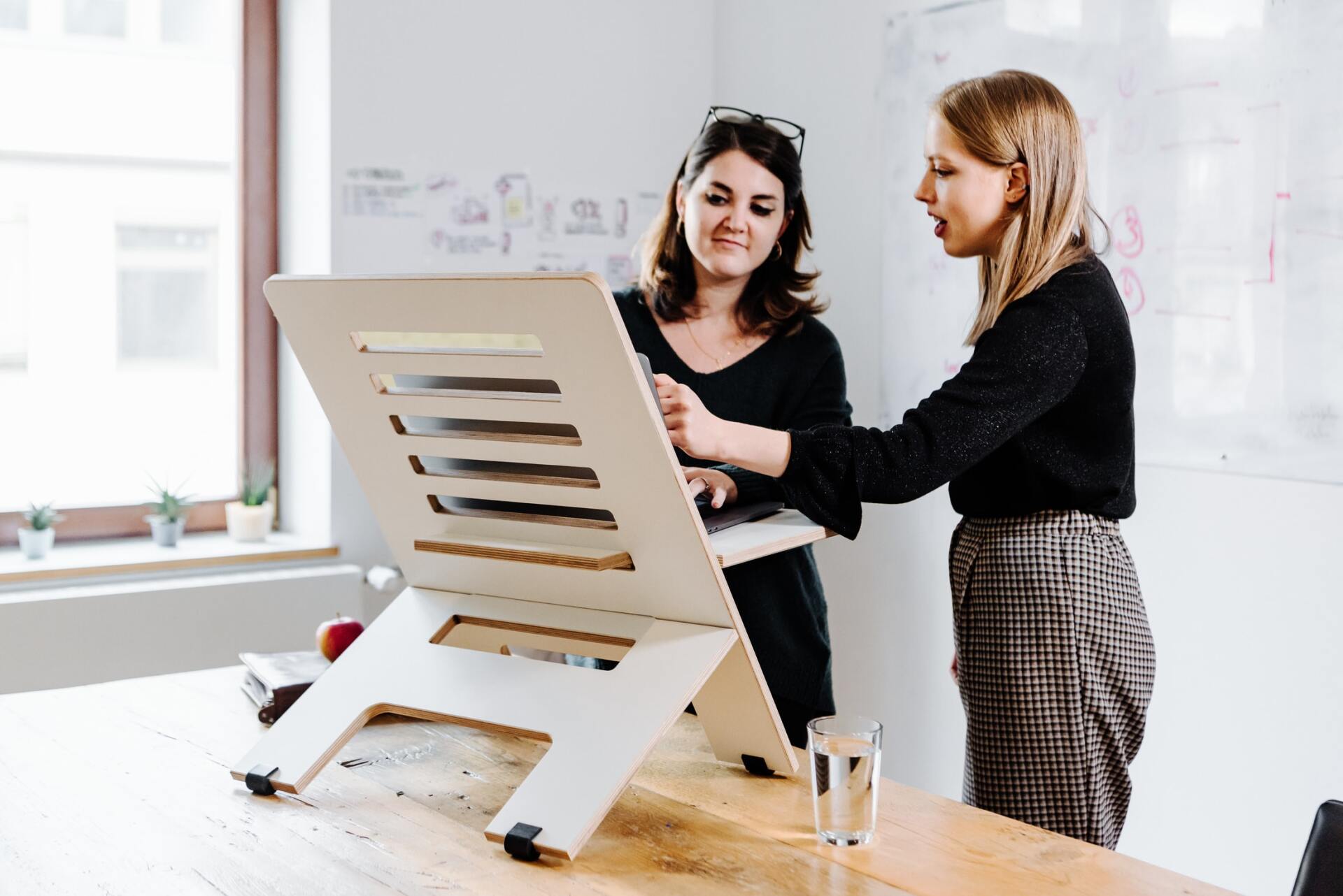Two women standing at a project management board Two women standing at a project management board