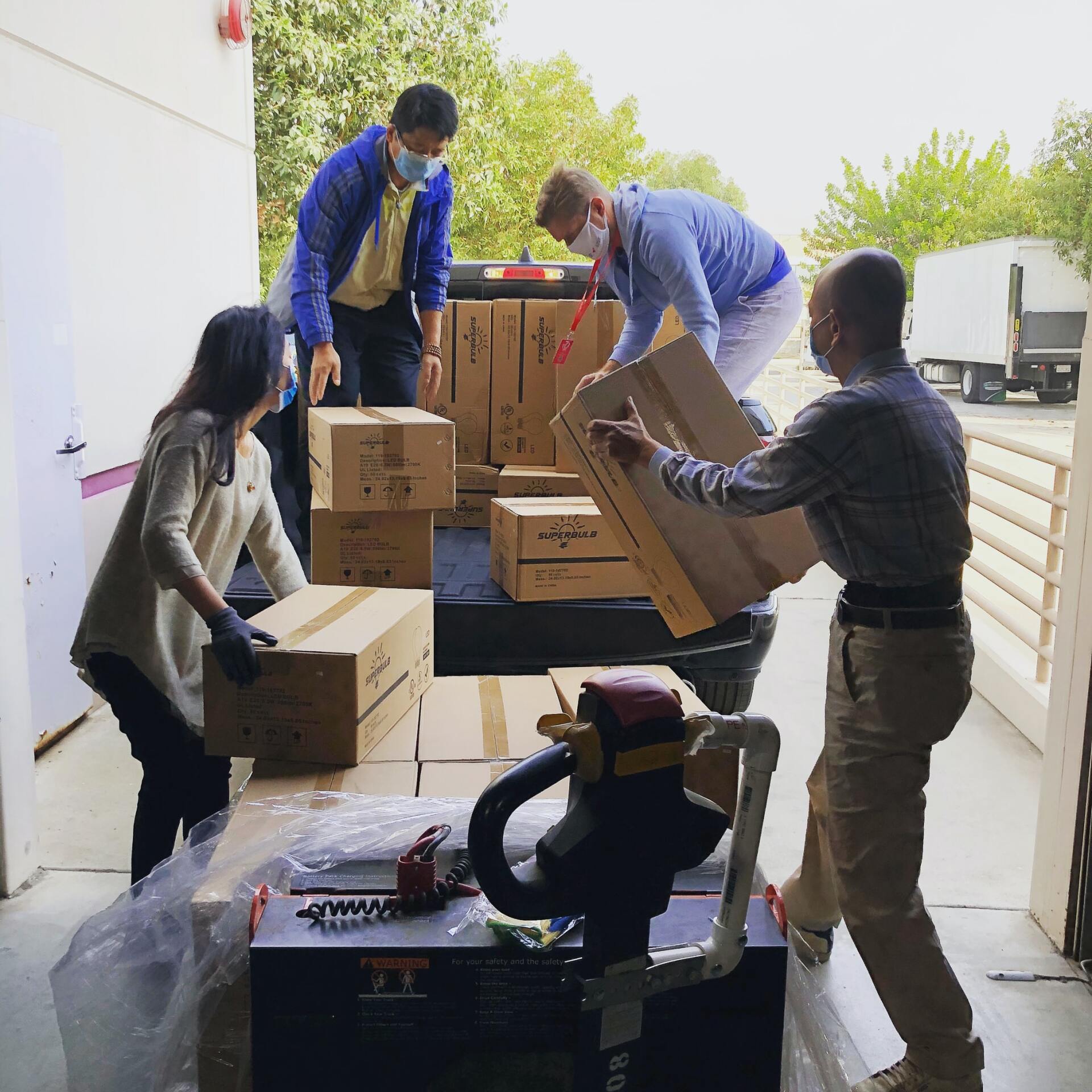 A group of people are loading boxes into a truck