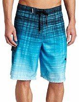 Blue and black gradient swim shorts with drawstring, worn by a person standing against a white background