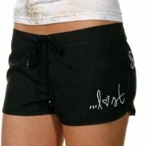 Black athletic shorts with white script logo on the front, worn with a white top
