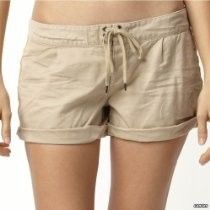 Beige drawstring shorts worn with rolled cuffs, front view