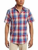 Man wearing a red, blue, and white plaid short-sleeve button-up shirt and beige pants