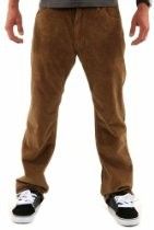 Person wearing brown pants and black-and-white sneakers standing against a white background