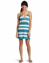 Woman standing in a blue-and-white striped dress against a white background
