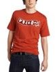 Person wearing a red graphic T-shirt and dark jeans, standing against a white background