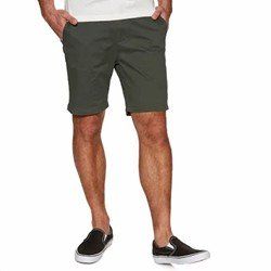 Man wearing dark green shorts and black slip-on shoes on a white background