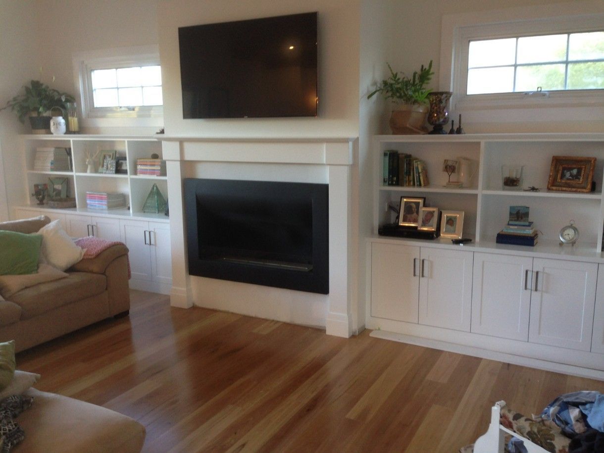 A Living Room With a Fireplace and a Flat Screen TV — High Kraft Kitchens and Joinery in Berkeley, NSW