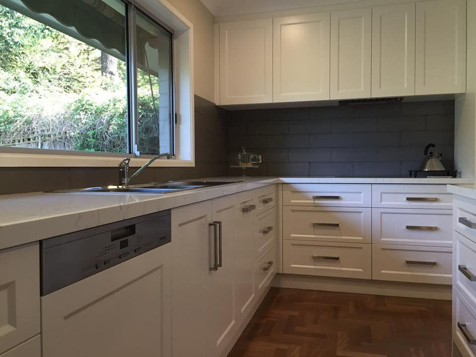A Kitchen With White Cabinets, a Sink, and a Window — High Kraft Kitchens and Joinery in Berkeley, NSW