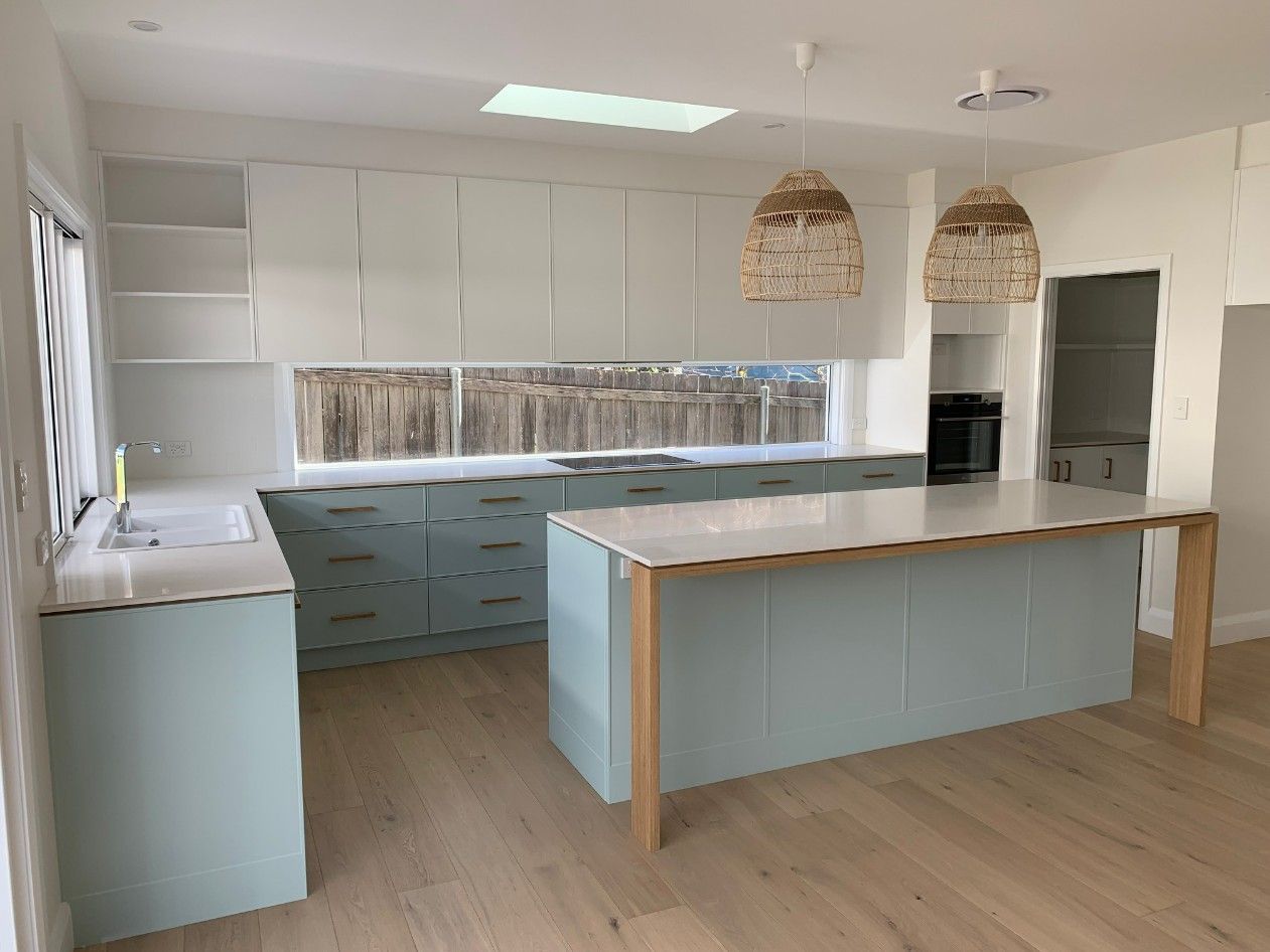 A Kitchen With Blue Cabinets and a Large Island — High Kraft Kitchens and Joinery in Berkeley, NSW