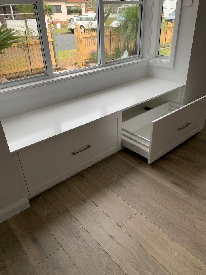 A White Bench With Drawers Underneath It in a Room Next to a Window — High Kraft Kitchens and Joinery in Berkeley, NSW