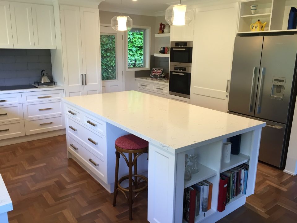 A Kitchen With White Cabinets and a Large Island in the Middle — High Kraft Kitchens and Joinery in Berkeley, NSW