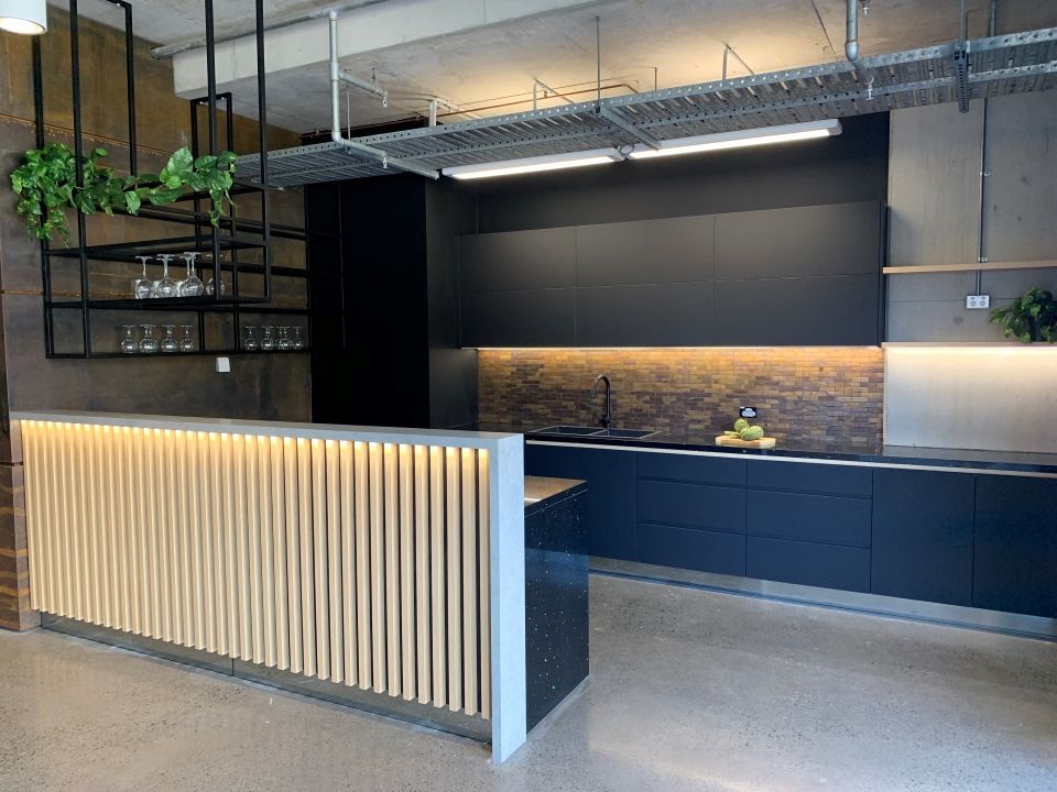 A Kitchen With Black Cabinets and a Wooden Counter Top — High Kraft Kitchens and Joinery in Berkeley, NSW
