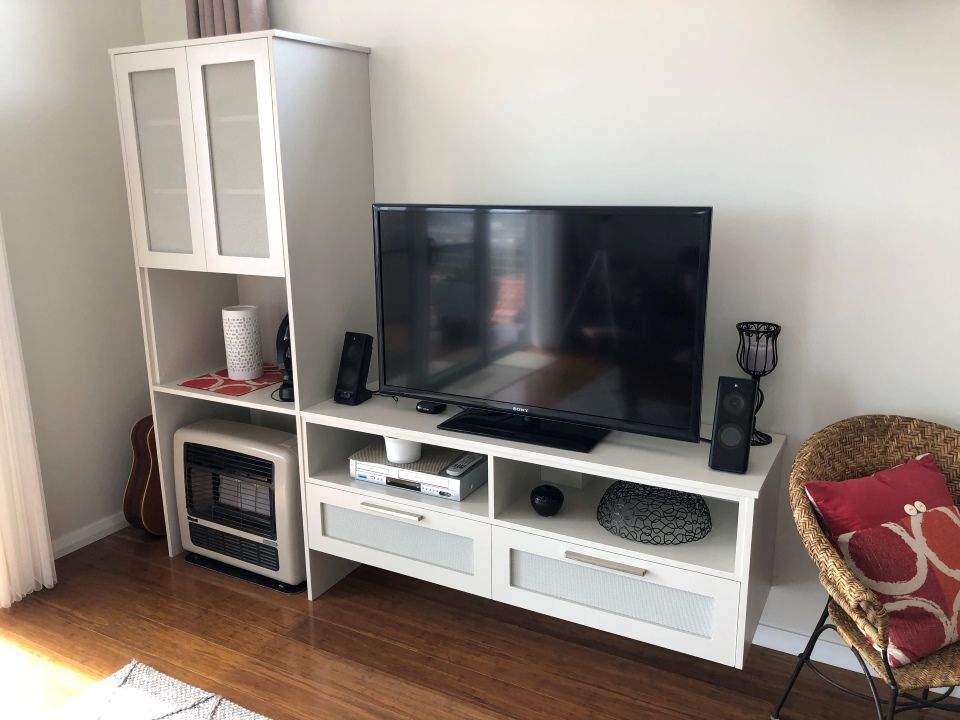 Living Room With a Flat Screen TV on a White Entertainment Center — High Kraft Kitchens and Joinery in Berkeley, NSW