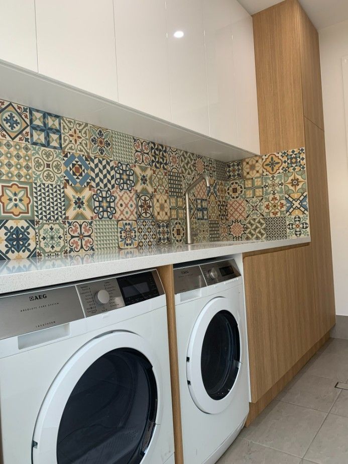 A Laundry Room With a Washer and Dryer — High Kraft Kitchens and Joinery in Berkeley, NSW
