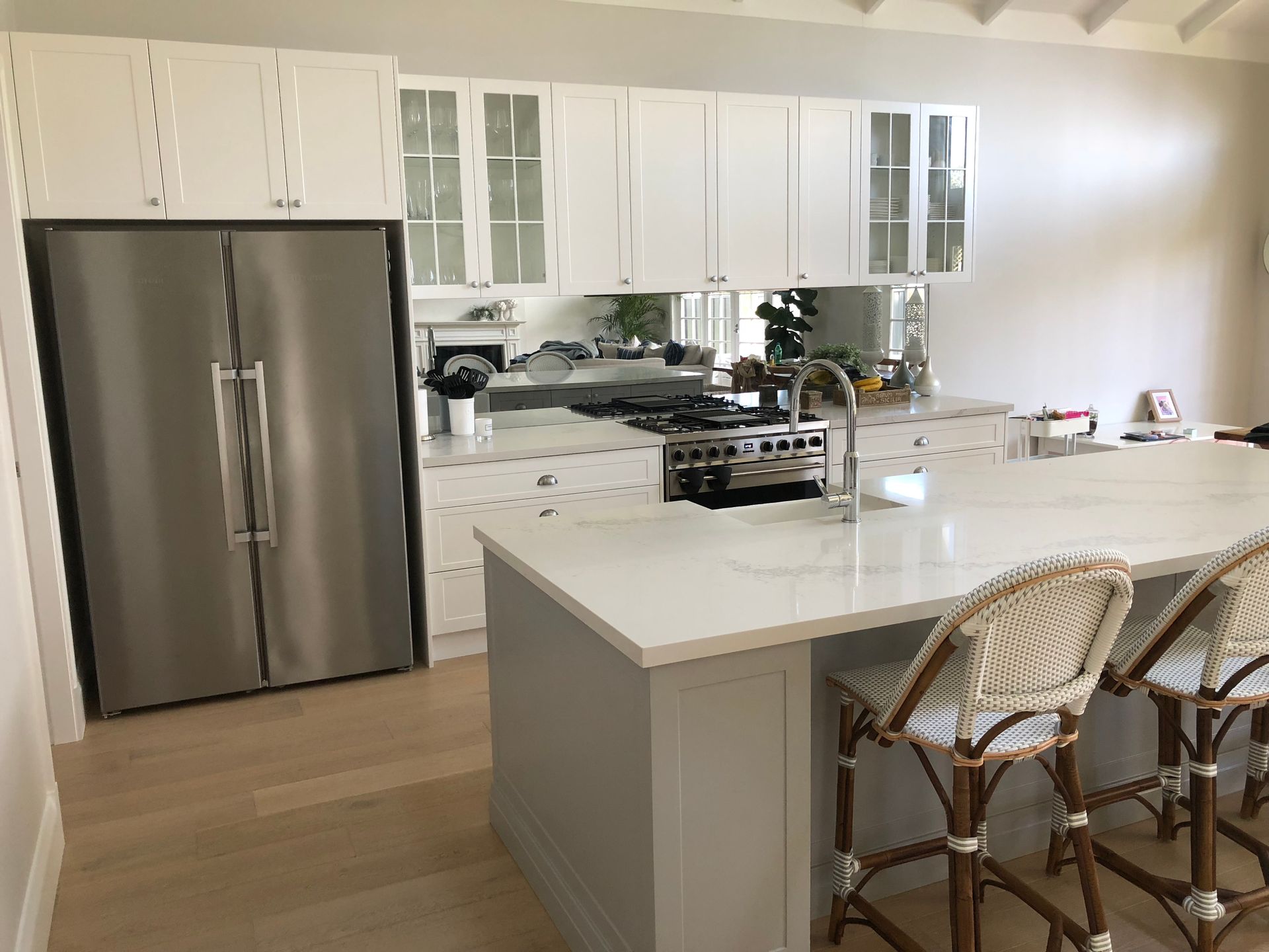 A Kitchen With a Large Island, Stools and a Refrigerator — High Kraft Kitchens and Joinery in Berkeley, NSW