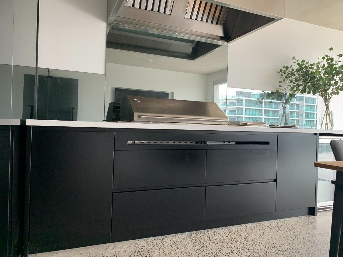 A Kitchen With Black Cabinets and a Grill on the Counter — High Kraft Kitchens and Joinery in Thirroul, NSW