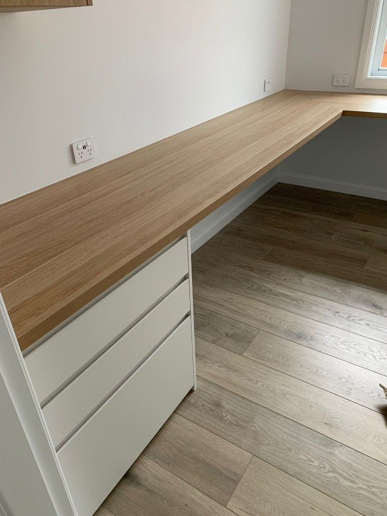 A Wooden Desk With a White Drawer Underneath It in a Room — High Kraft Kitchens and Joinery in Berkeley, NSW