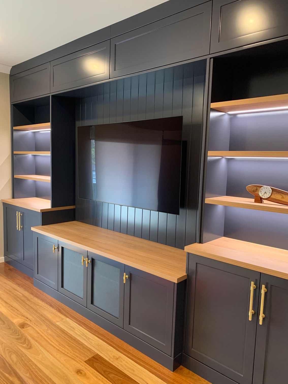 A Living Room With TV in Grey Cabinet— High Kraft Kitchens and Joinery in Berkeley, NSW