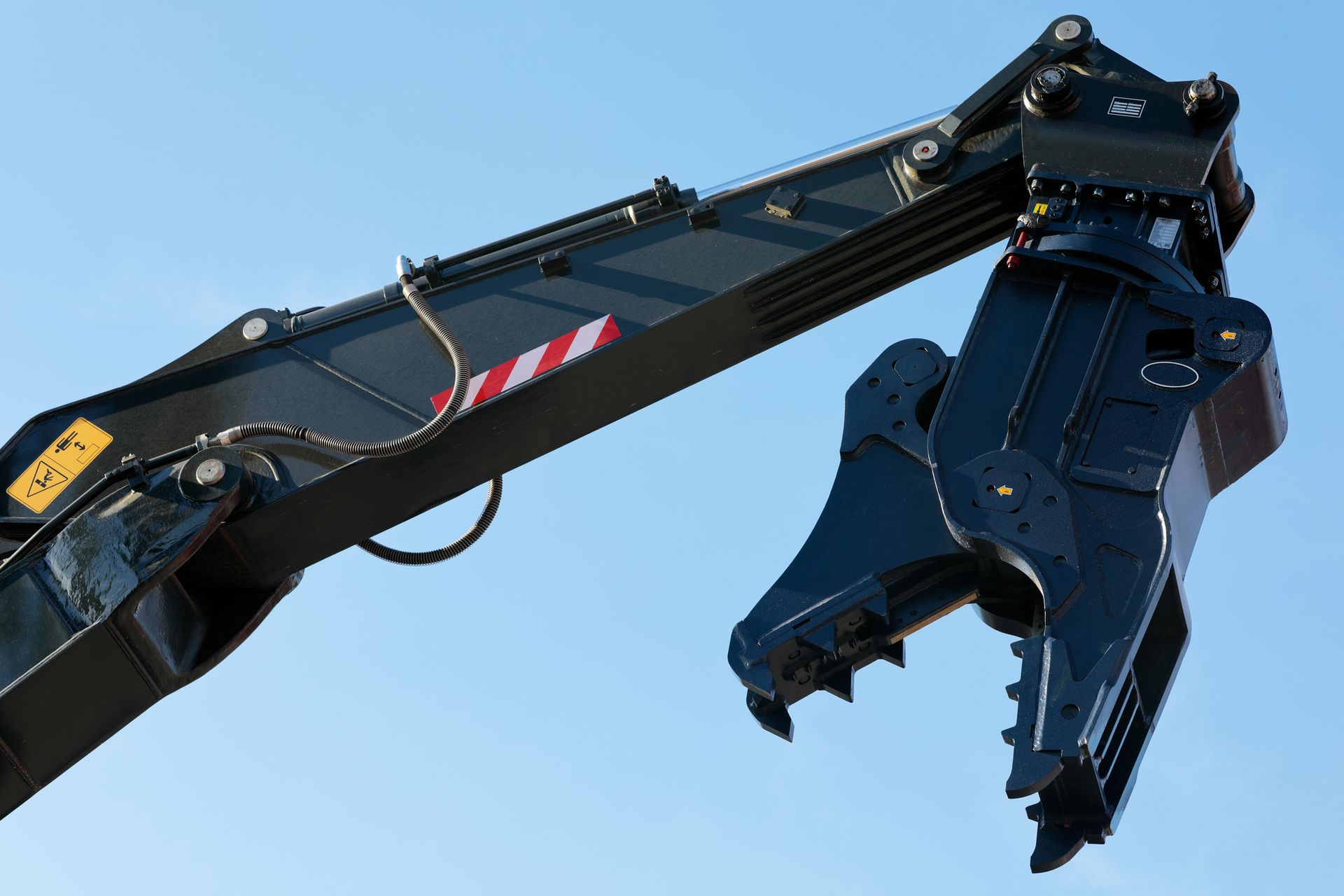 Heavy-duty excavator attachment used for demolition work by professional jaw crusher hire service.