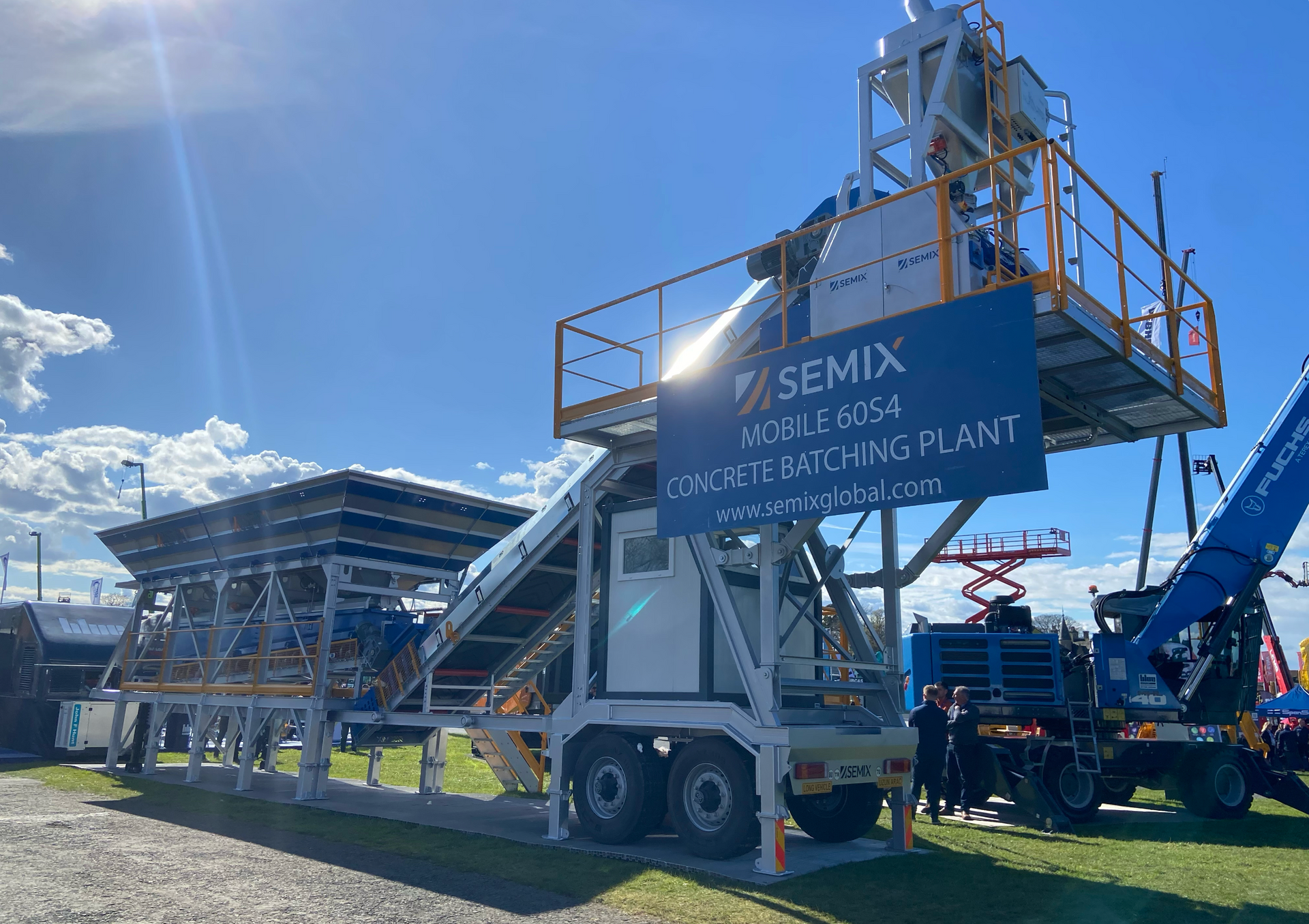 A Semix mobile concrete batching plant on display outdoors with a bright sky.