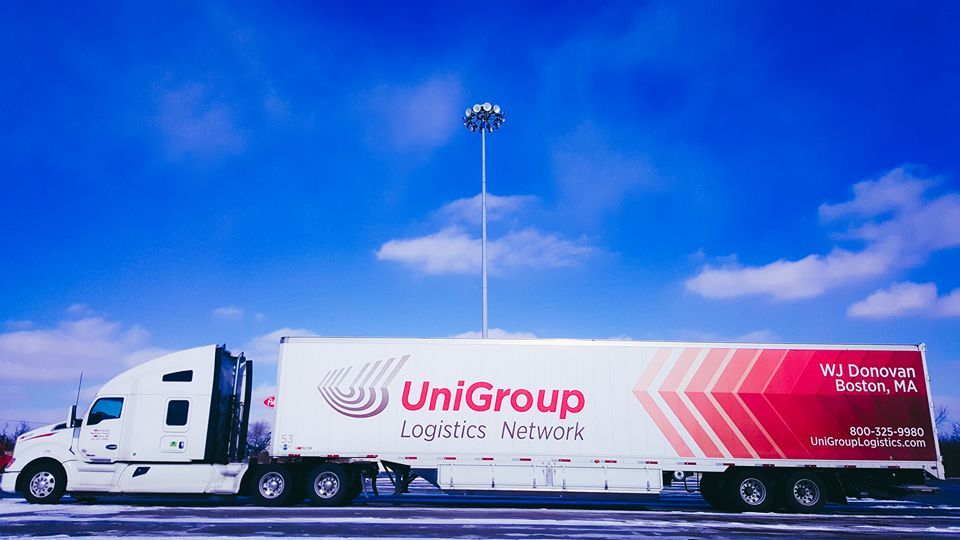 UniGroup Logistics truck parked under a bright blue sky