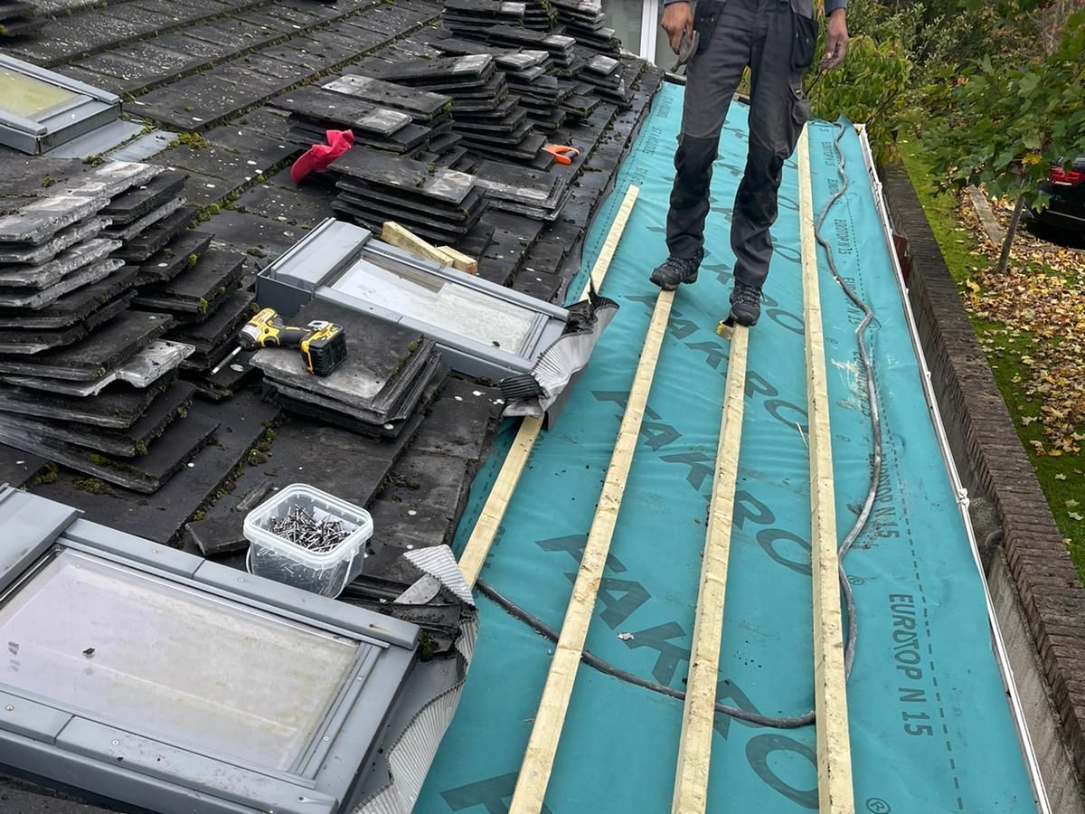 A man is standing on the roof of a building.