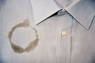 A light-colored fabric with a noticeable, jagged hole in the center.