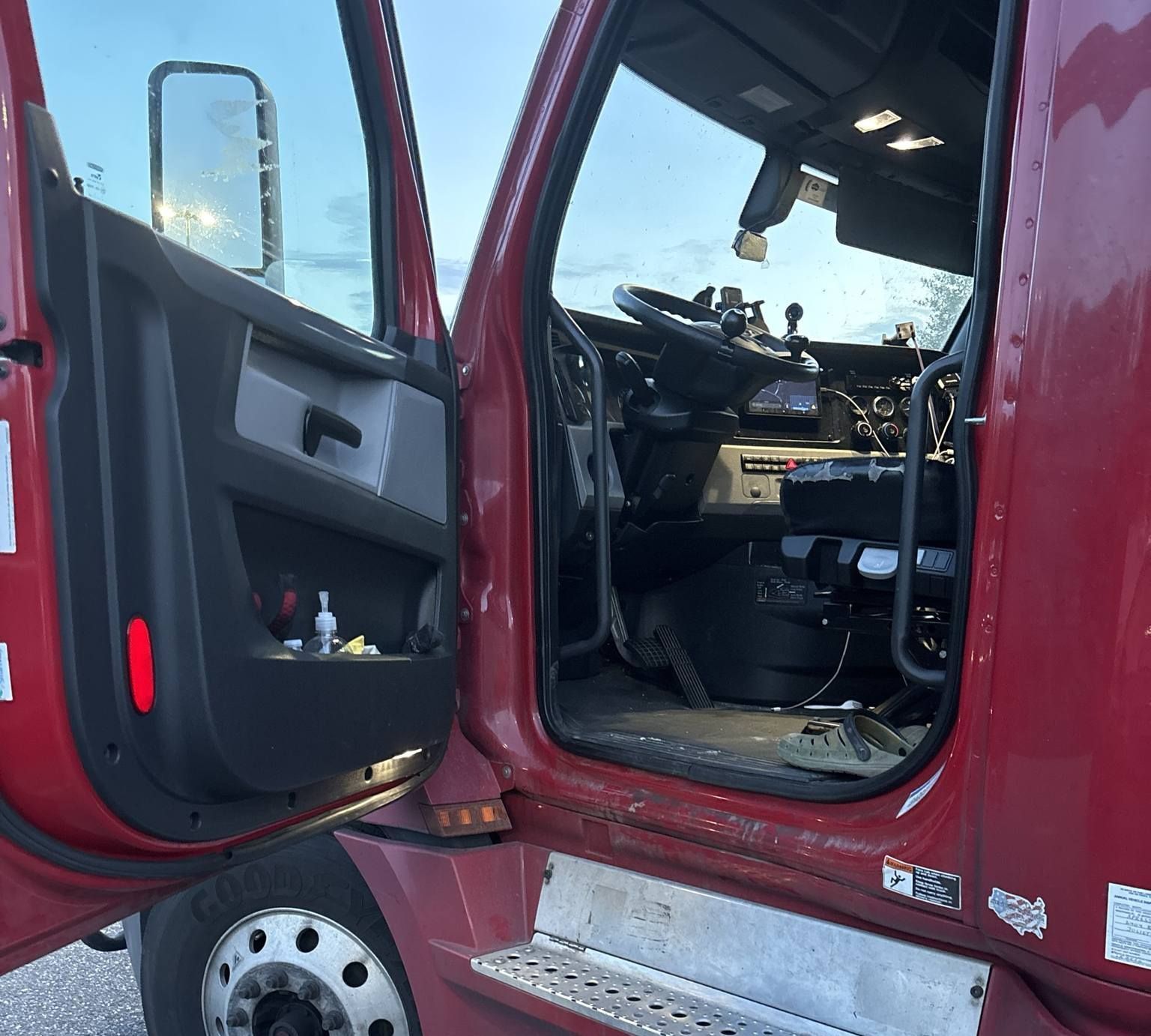 The inside of a red truck with the door open