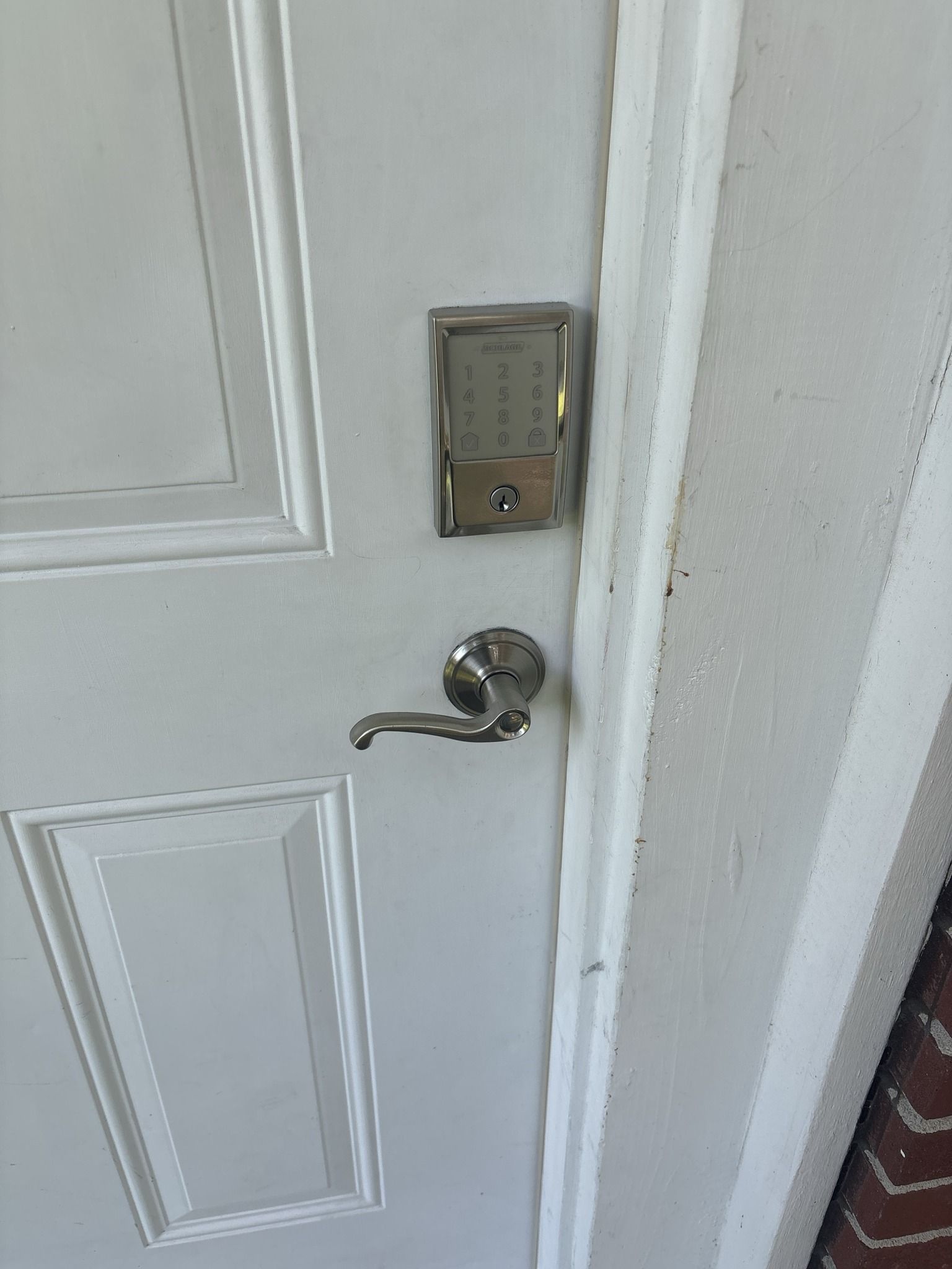 A close up of a door with a keypad on it.