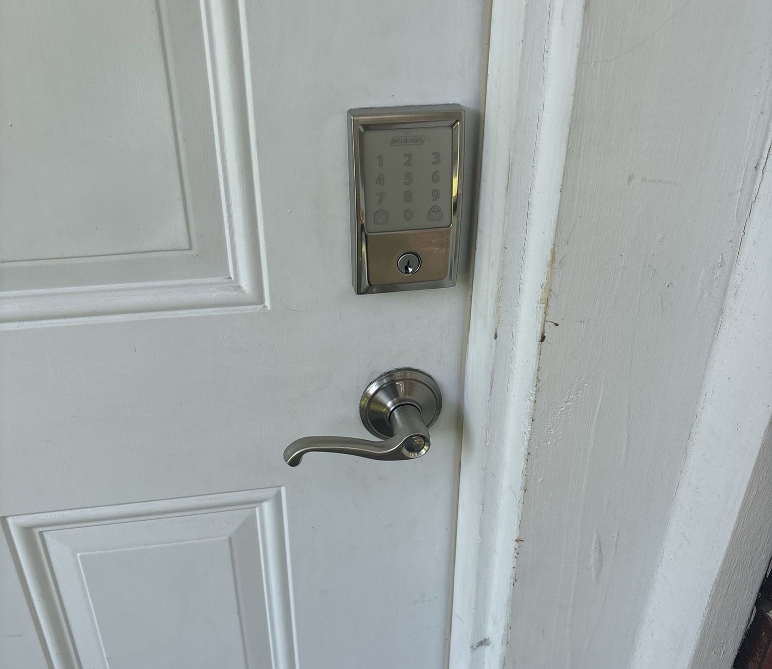A close up of a door with a keypad on it.
