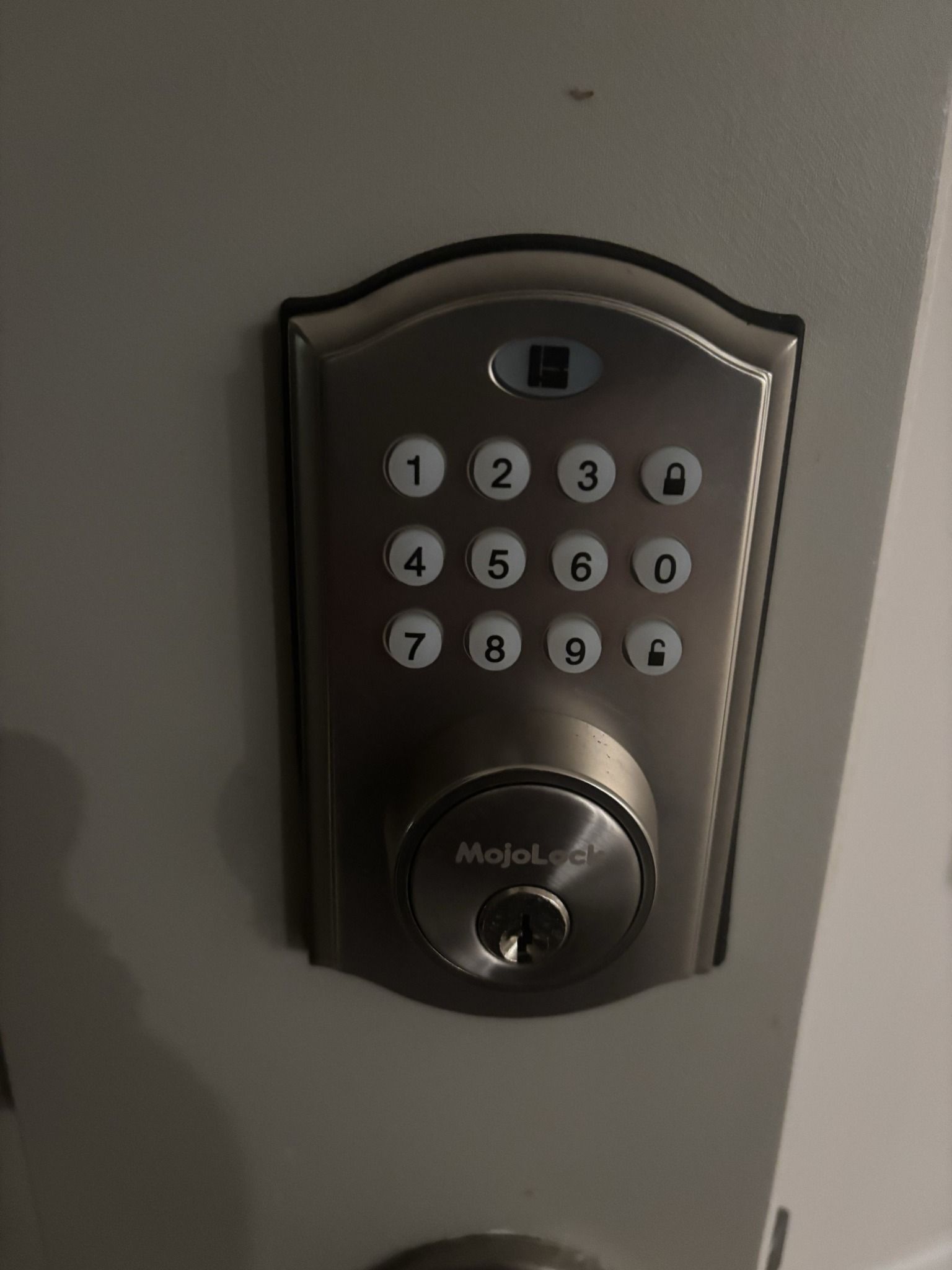 A digital door lock with a key on it