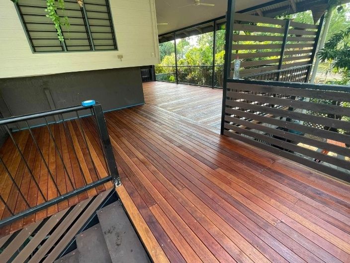 Wooden Deck Extending From a House With Dark Wood Railings — Northco Constructions In Muirhead, NT