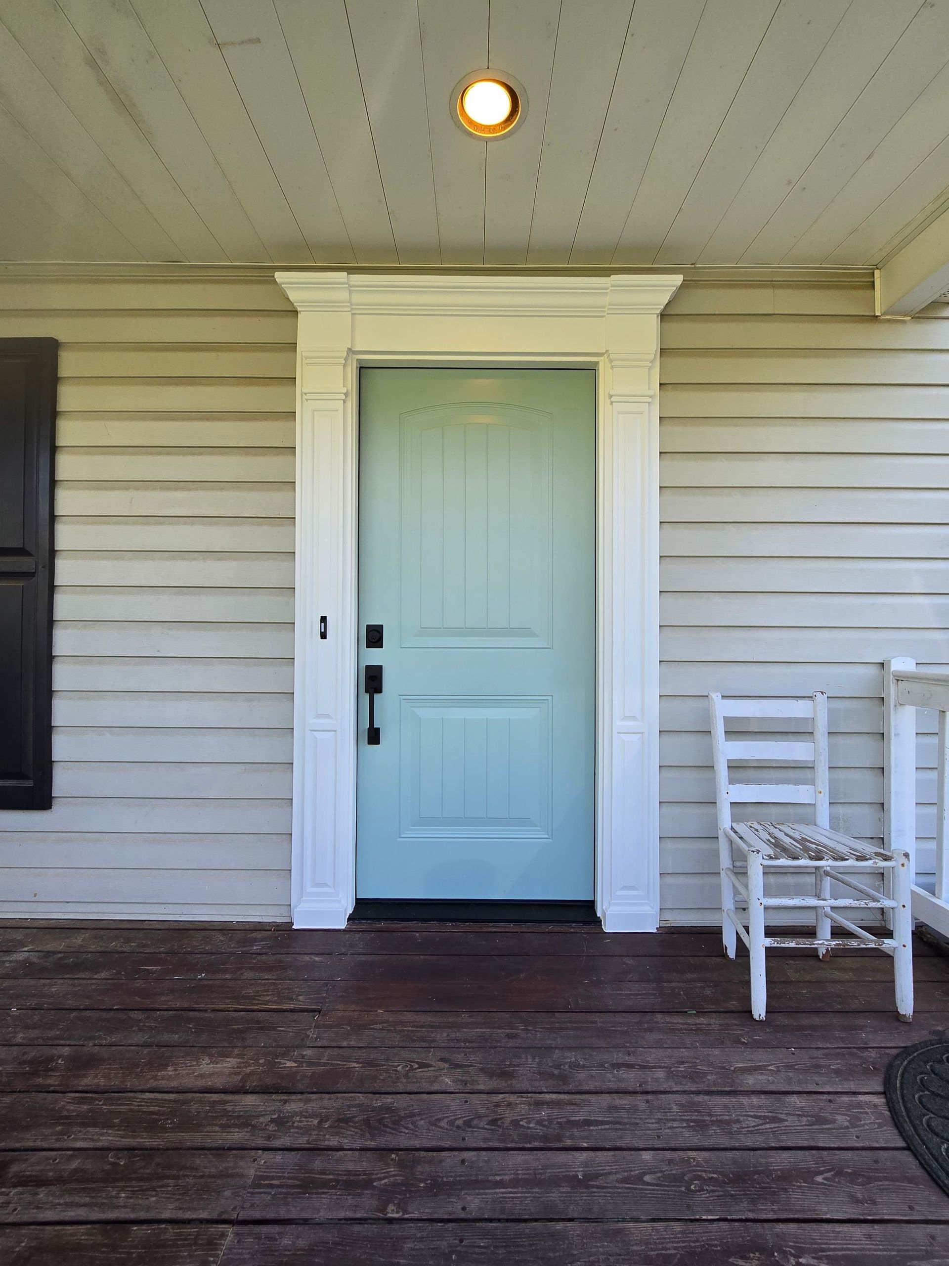 The front door of a house has a light above it