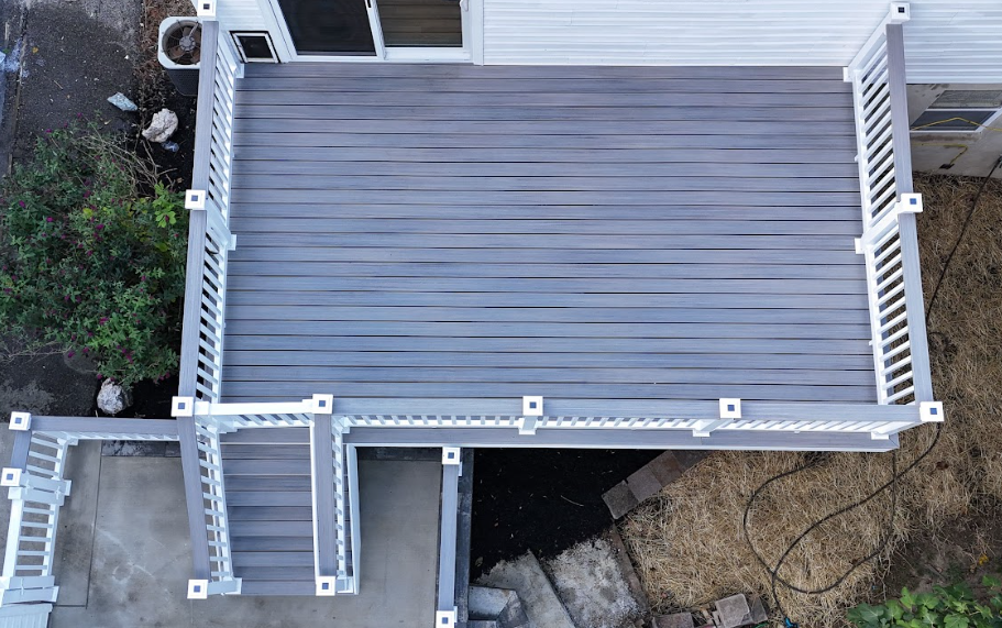 An aerial view of a deck with stairs and a white railing.