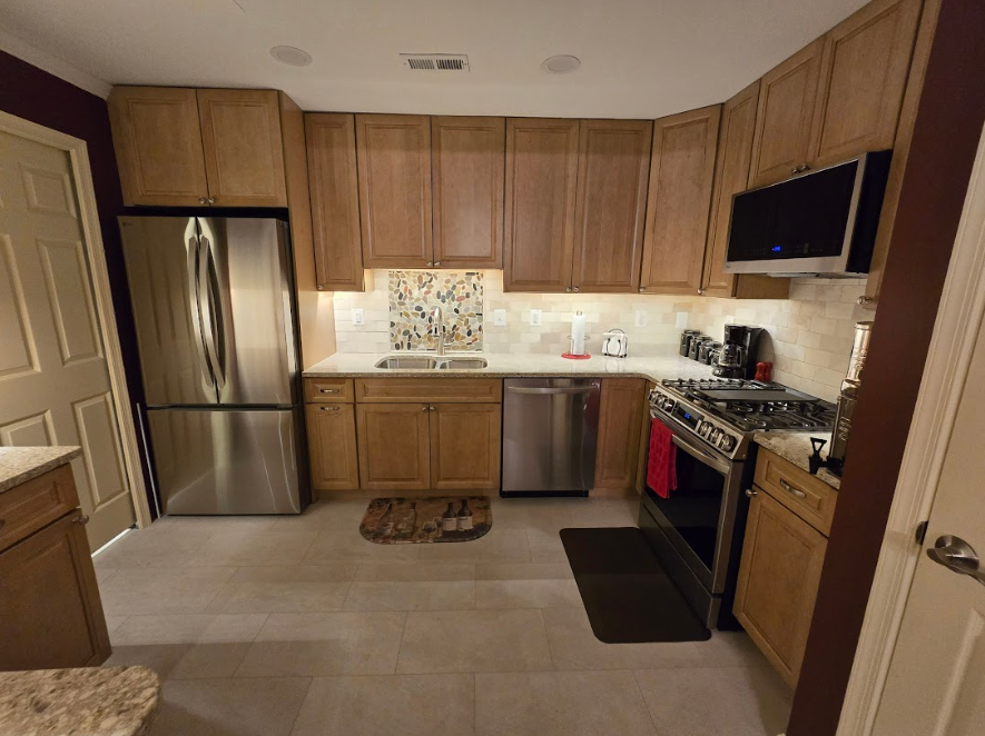 A kitchen with stainless steel appliances and wooden cabinets