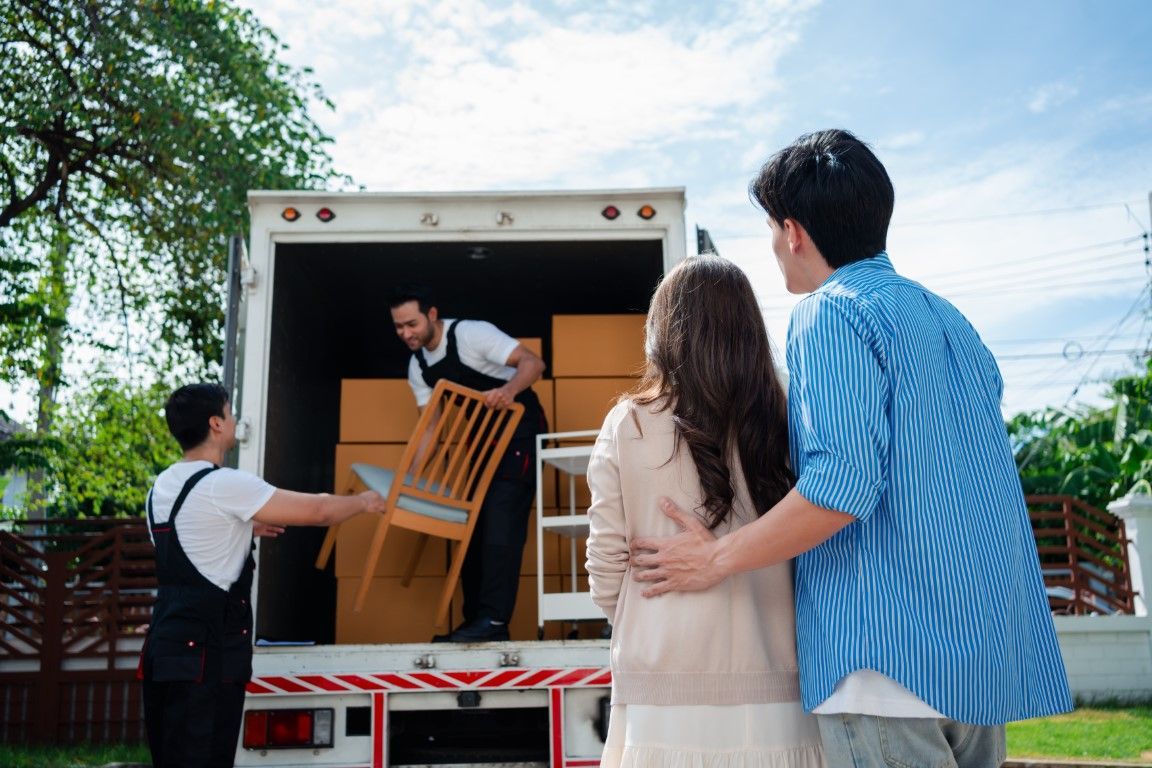 “Team lifting furniture onto a truck for removal”
