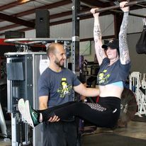 Personal Trainer Working At The Gym — St. Augustine, FL — Amp Hardcore Gym