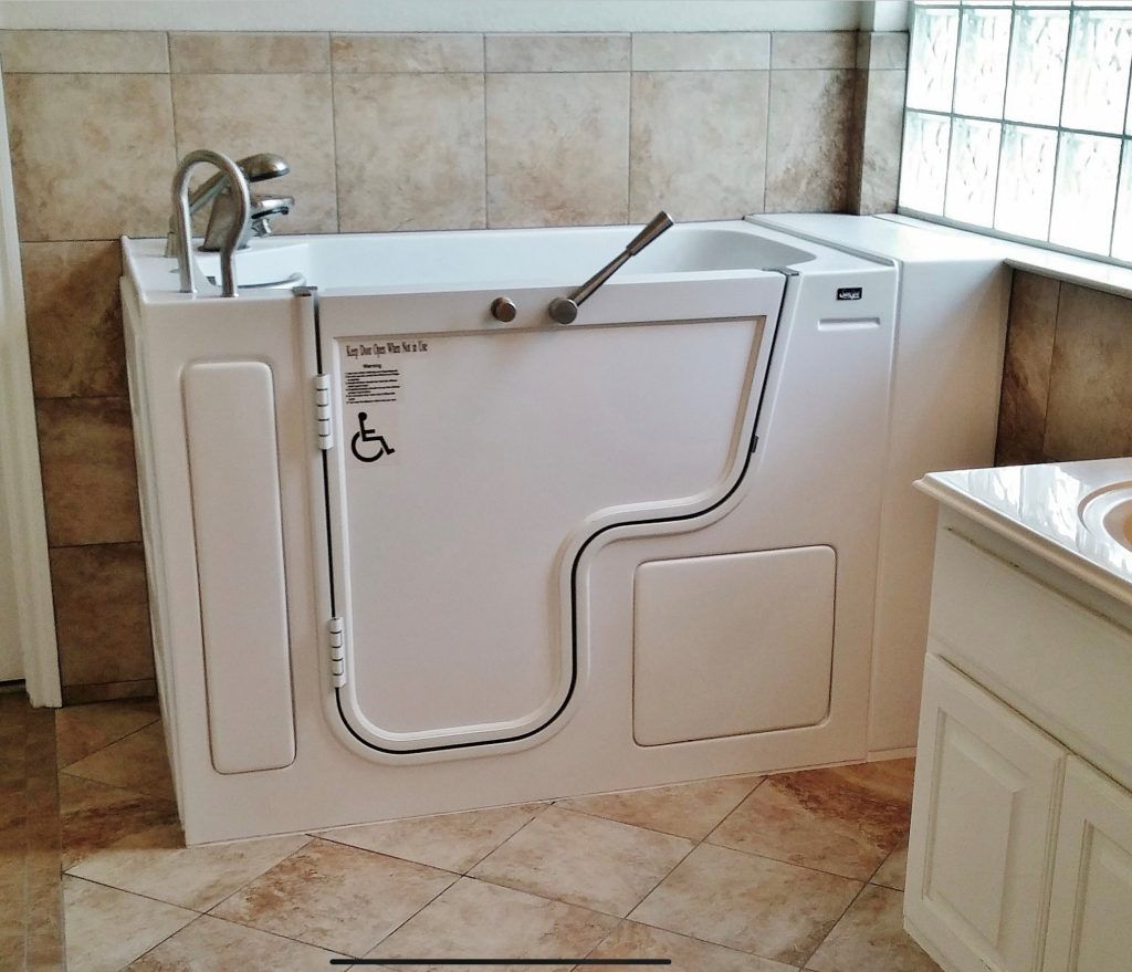 White walk in bath tub that is handicapped accessible. 
