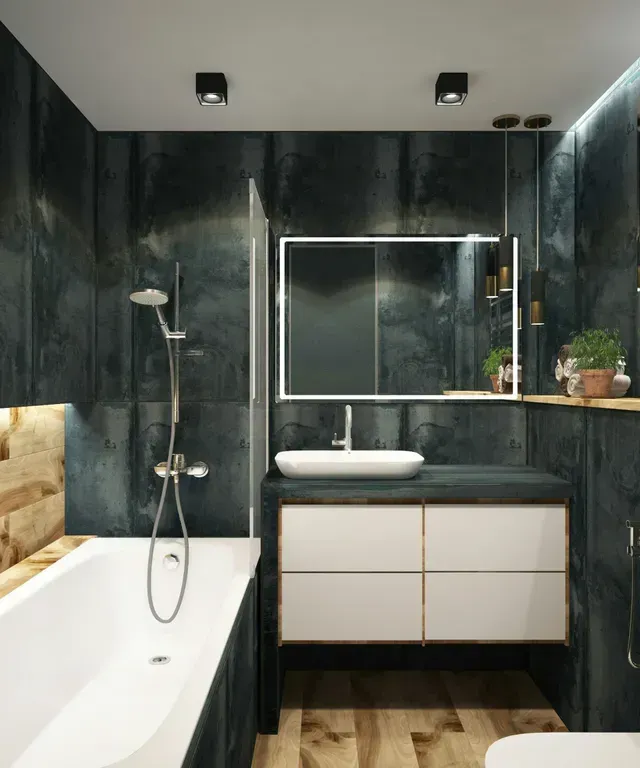 A beautifully remodeled bathroom with black tile walls, a big white tub, and a stainless steel flexible shower head.