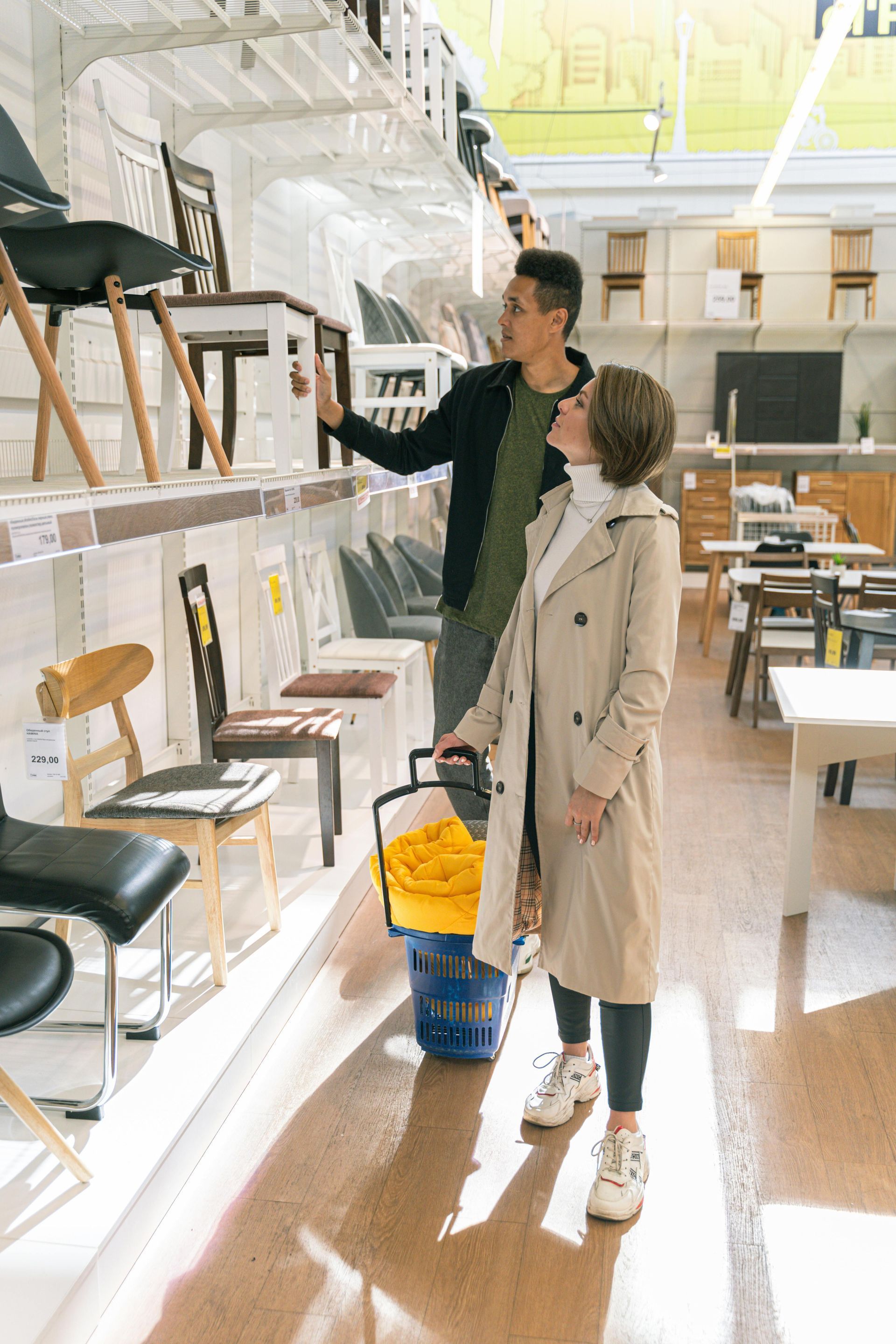 Husband and wife shopping at a furniture store for new furnishings.