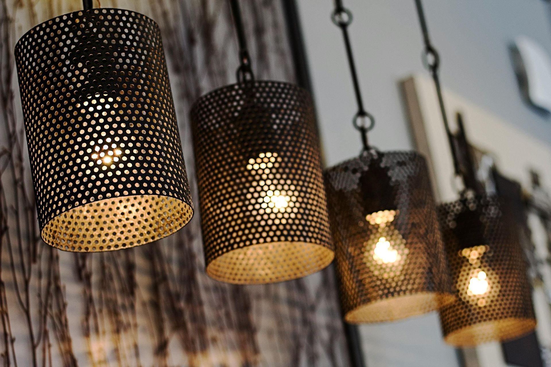Four bronze farmhouse hanging lighting fixtures.