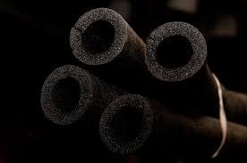 Four black foam pipe insulation tubes with a semi slit.