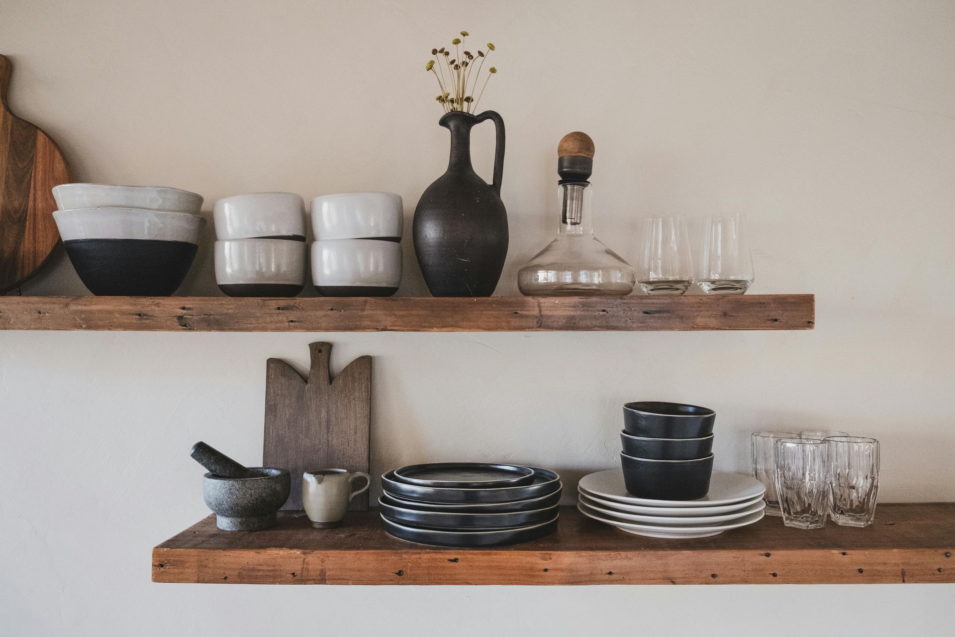 Two floating shelves with plates, cups, and bowls.