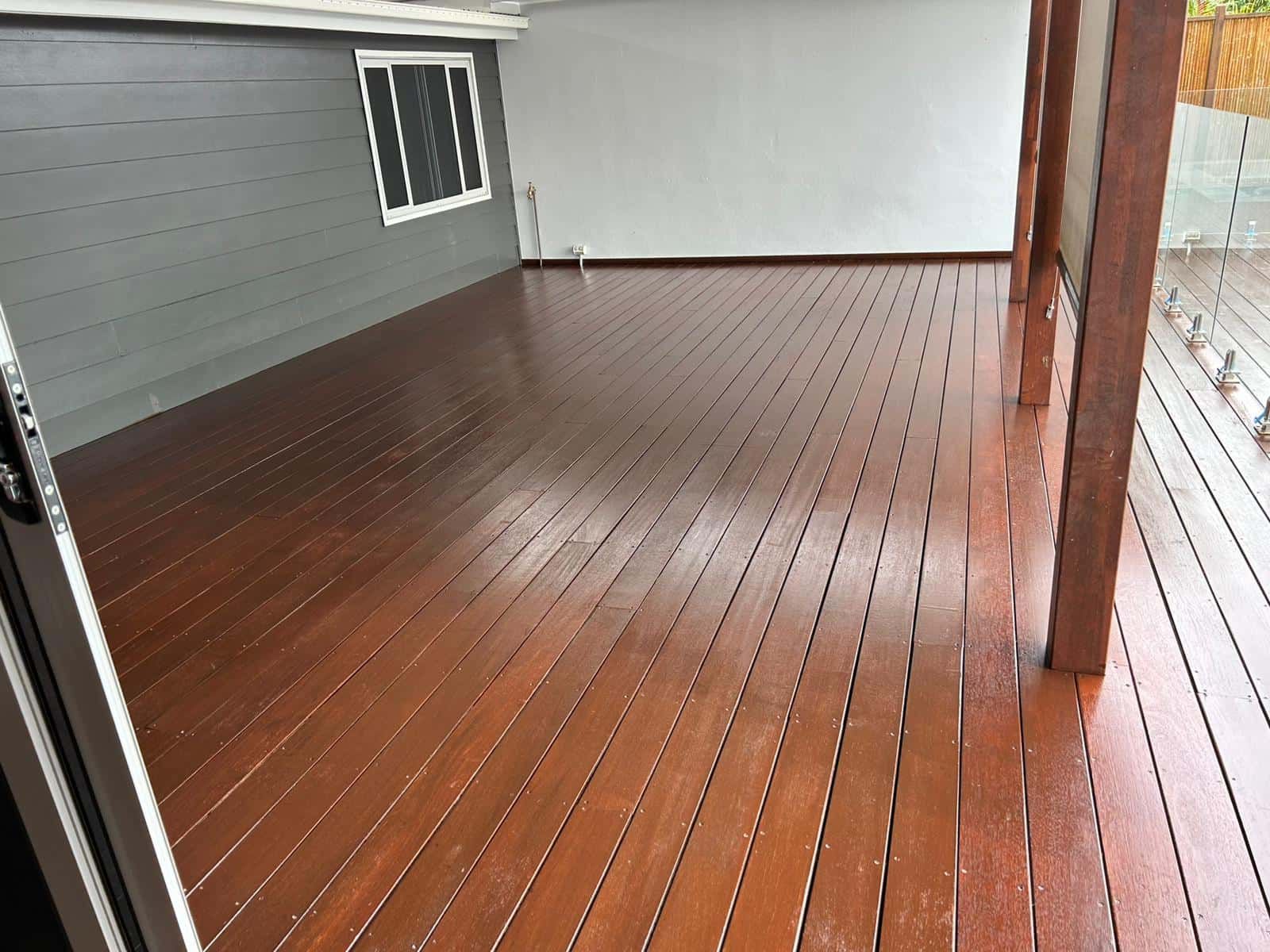 A Wooden Deck With A Sliding Glass Door And A Window — Tweed Heads Painting Service In Condong, NSW