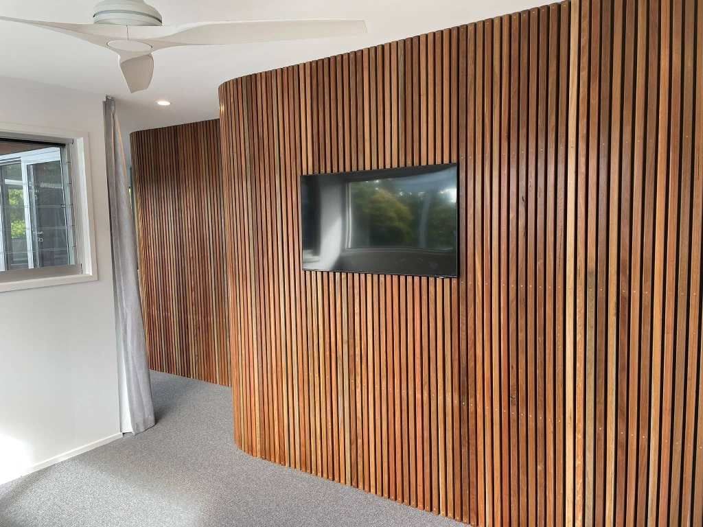 A Bedroom With A Wooden Wall And A Flat Screen Tv — Tweed Heads Painting Service In Condong, NSW