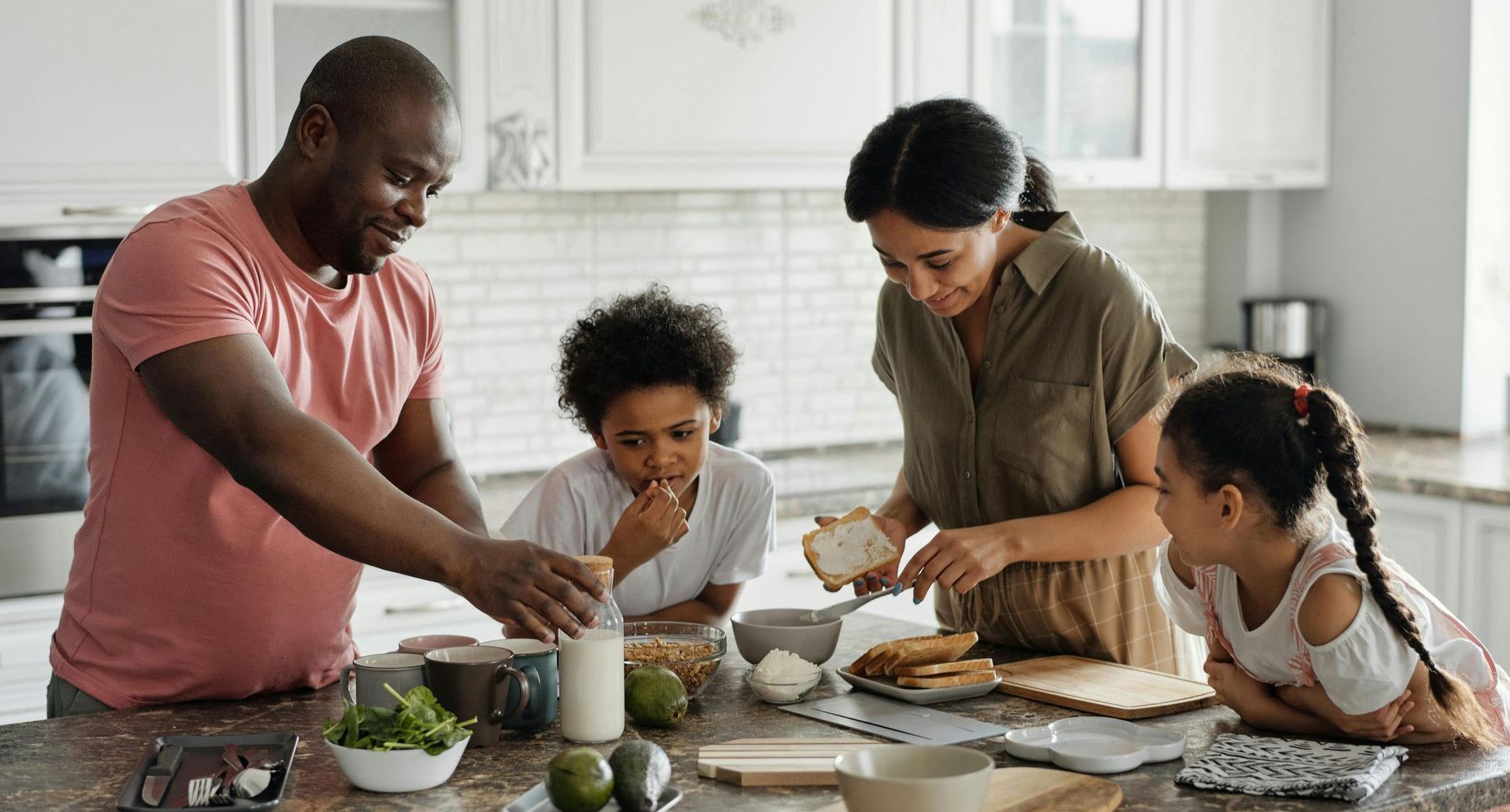 A family is preparing food together in the kitchen.